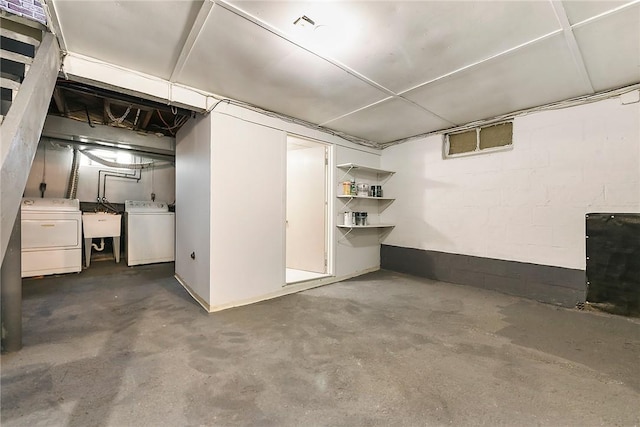 basement with separate washer and dryer and sink