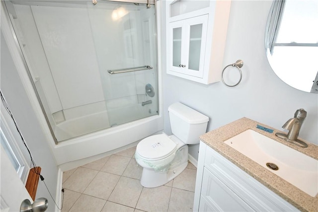 full bathroom featuring tile patterned flooring, vanity, bath / shower combo with glass door, and toilet