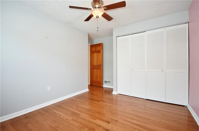 unfurnished bedroom with ceiling fan, light hardwood / wood-style floors, and a closet