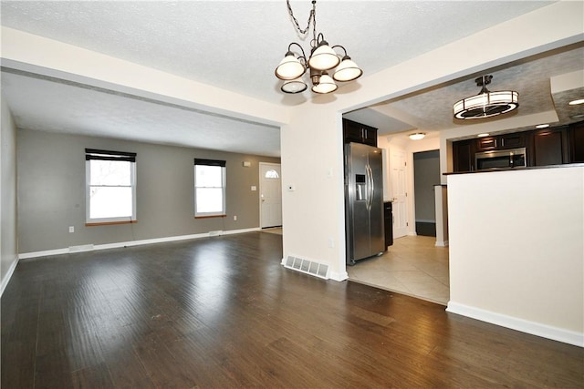 interior space featuring hardwood / wood-style floors, a chandelier, and a textured ceiling