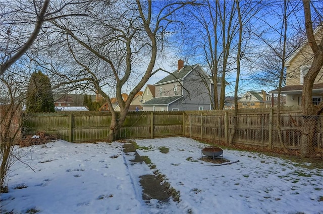 snowy yard with an outdoor fire pit