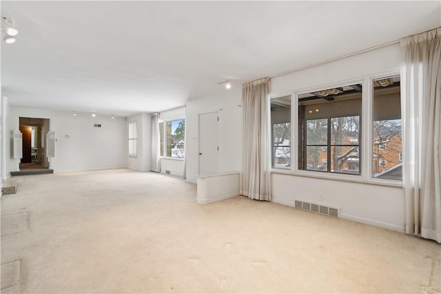 unfurnished living room featuring light carpet