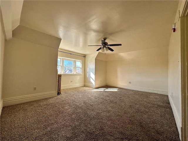 additional living space with ceiling fan and carpet flooring