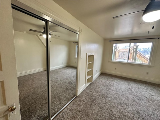 unfurnished bedroom featuring carpet flooring, ceiling fan, and a closet