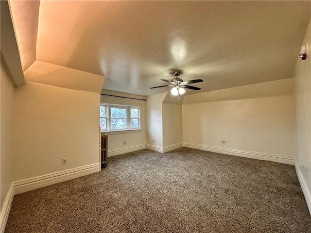 bonus room with carpet floors and ceiling fan