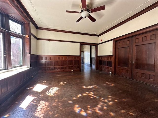 unfurnished living room with ceiling fan and crown molding