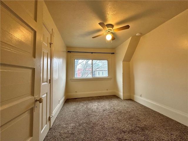 additional living space featuring a textured ceiling, carpet flooring, and ceiling fan