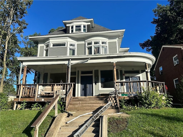 victorian home with covered porch and a front lawn