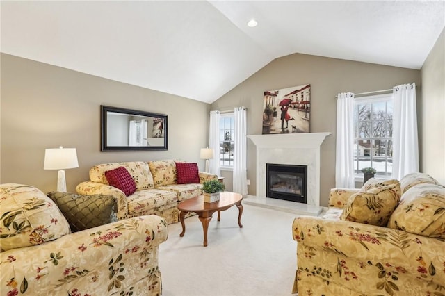 carpeted living room with lofted ceiling and a fireplace