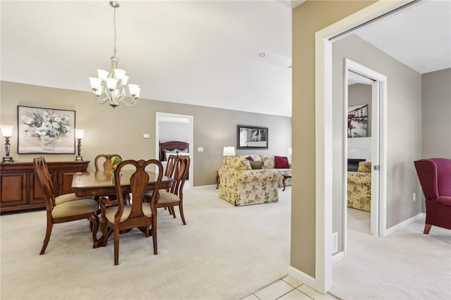 carpeted dining room with vaulted ceiling and an inviting chandelier