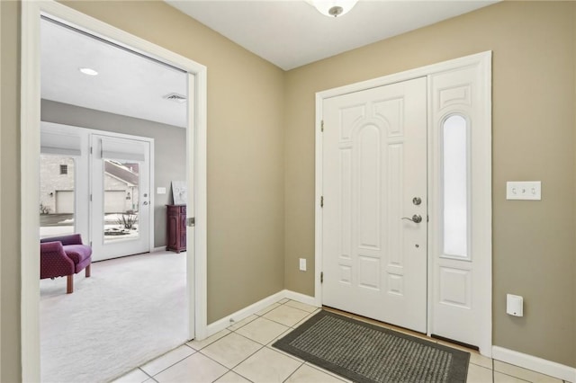 foyer entrance with light tile patterned floors