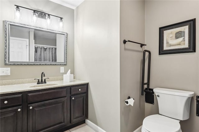 bathroom featuring vanity, tile patterned floors, and toilet