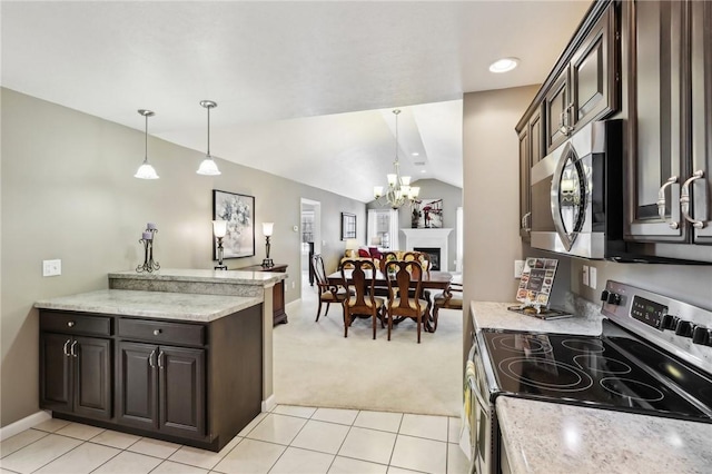 kitchen with vaulted ceiling, appliances with stainless steel finishes, pendant lighting, and dark brown cabinetry