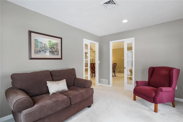 carpeted living room featuring french doors