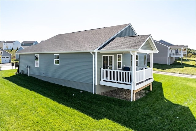 view of side of home with a yard