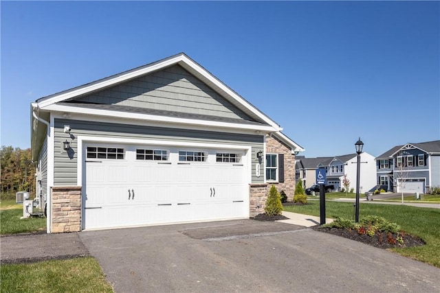 view of front of property with a garage and a front lawn