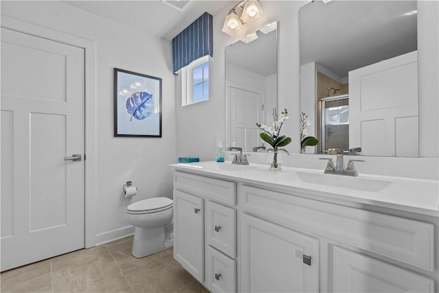 bathroom with vanity, toilet, and a shower with shower door