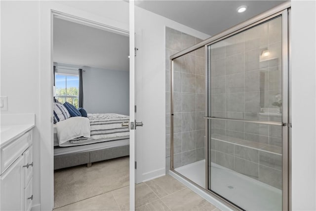 bathroom featuring walk in shower, tile patterned floors, and vanity