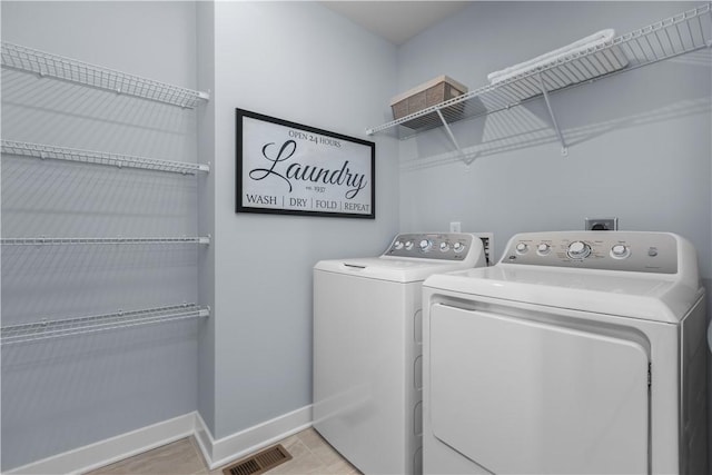 clothes washing area featuring independent washer and dryer