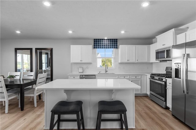 kitchen with a center island, white cabinets, and appliances with stainless steel finishes