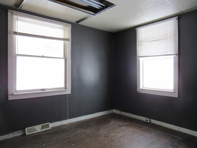 spare room featuring dark hardwood / wood-style flooring