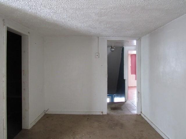 spare room with a textured ceiling