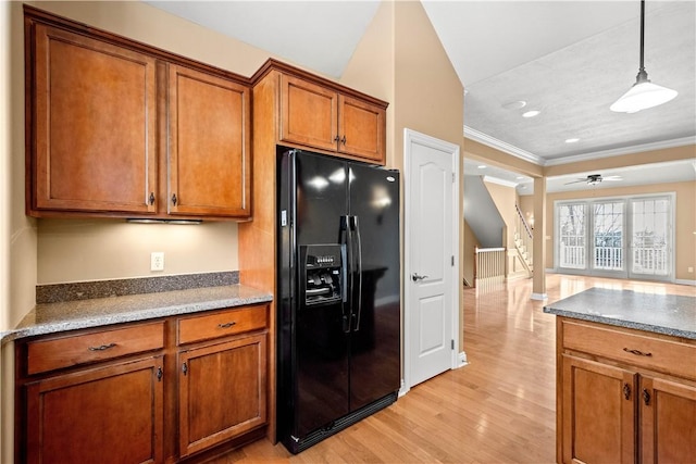 kitchen featuring crown molding, ceiling fan, hanging light fixtures, light hardwood / wood-style floors, and black refrigerator with ice dispenser