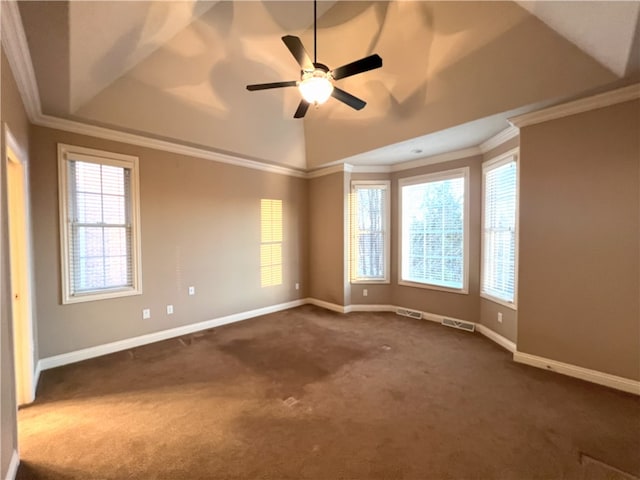 carpeted empty room featuring ceiling fan, ornamental molding, a raised ceiling, and a wealth of natural light