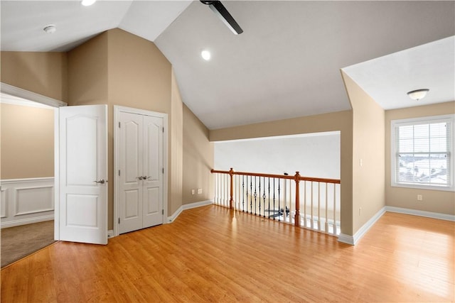 bonus room featuring ceiling fan, lofted ceiling, and light wood-type flooring