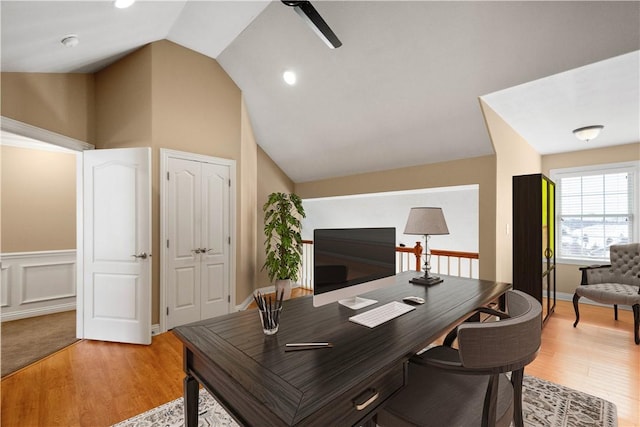 office area with vaulted ceiling, ceiling fan, and light hardwood / wood-style flooring