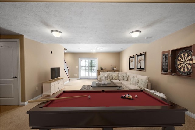 game room featuring light carpet and a textured ceiling