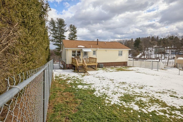 snow covered property with a wooden deck