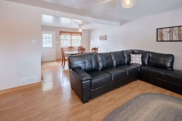 living room featuring ceiling fan and light hardwood / wood-style flooring