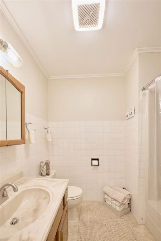 bathroom featuring tile walls, ornamental molding, vanity, toilet, and tile patterned floors