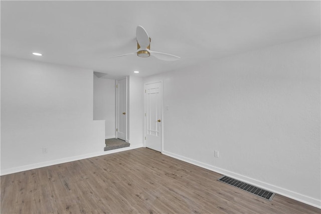 unfurnished room with hardwood / wood-style flooring and ceiling fan