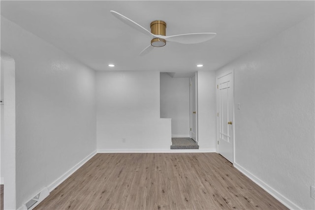 spare room featuring light hardwood / wood-style floors and ceiling fan