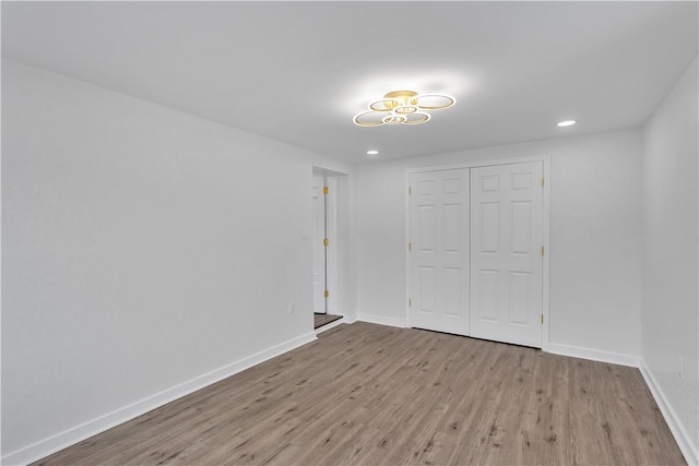 unfurnished bedroom featuring a closet and light wood-type flooring