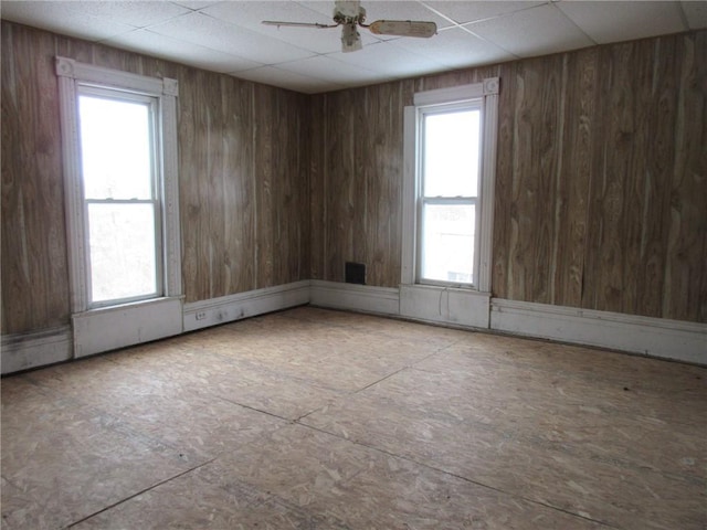 unfurnished room with a paneled ceiling and ceiling fan