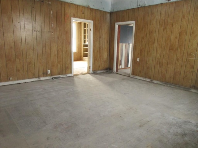 empty room featuring wooden walls