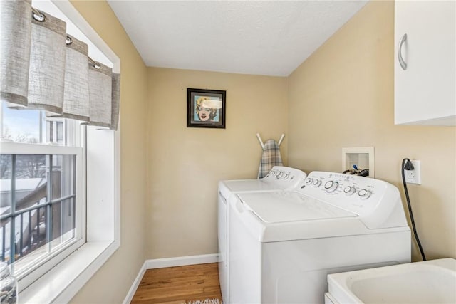 laundry area with sink, hardwood / wood-style floors, and washing machine and clothes dryer