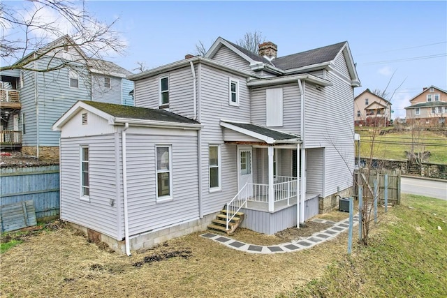 view of front of home featuring a front yard and central air condition unit