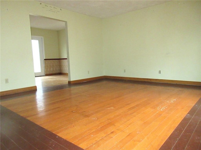 spare room featuring wood-type flooring