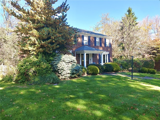 colonial-style house with a front lawn