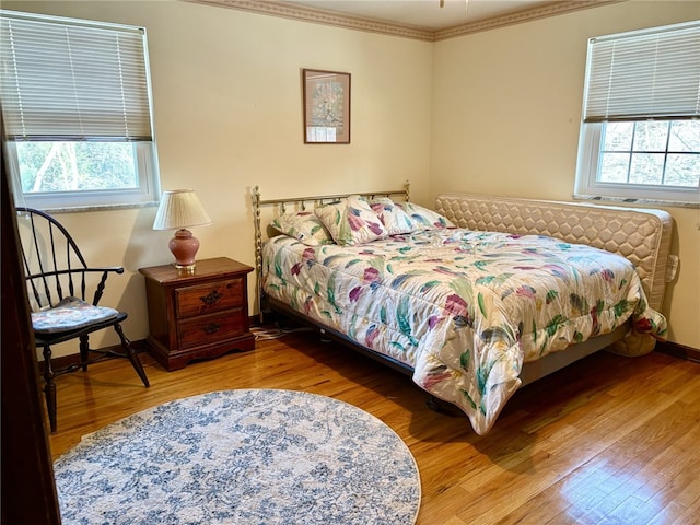 bedroom featuring hardwood / wood-style floors and crown molding