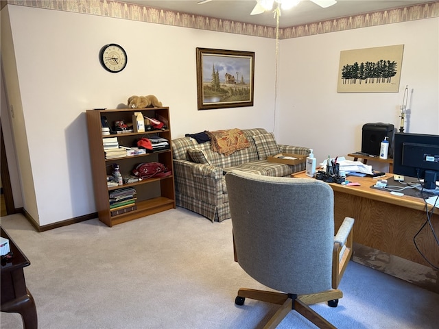 carpeted office space featuring ceiling fan