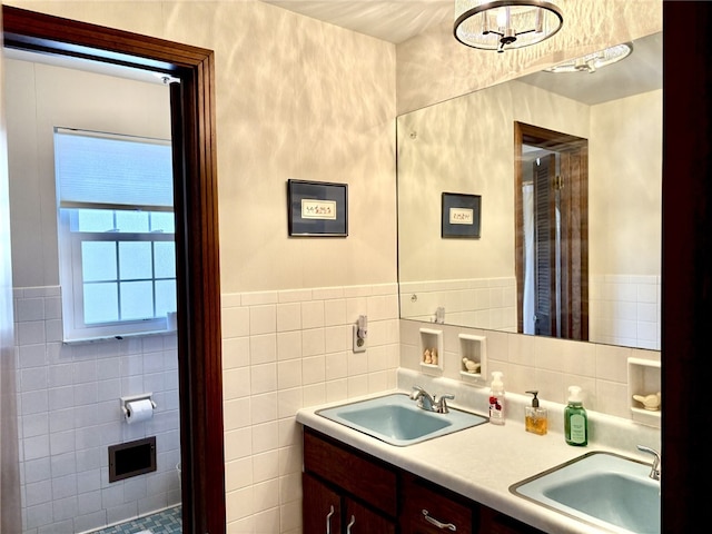 bathroom featuring vanity and tile walls