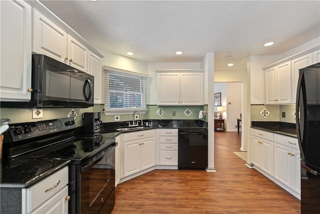 kitchen with white cabinetry, sink, light wood-type flooring, and black appliances