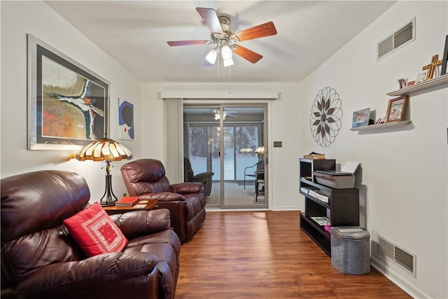 living room featuring dark hardwood / wood-style flooring and ceiling fan