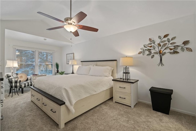 bedroom featuring ceiling fan, lofted ceiling, and light carpet