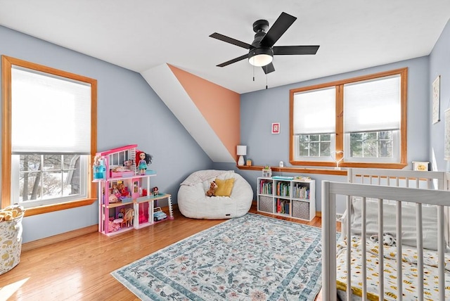 bedroom featuring multiple windows and hardwood / wood-style floors